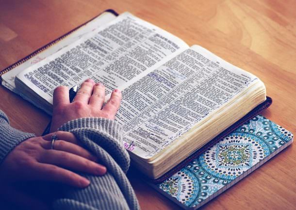 reading bible on beach
