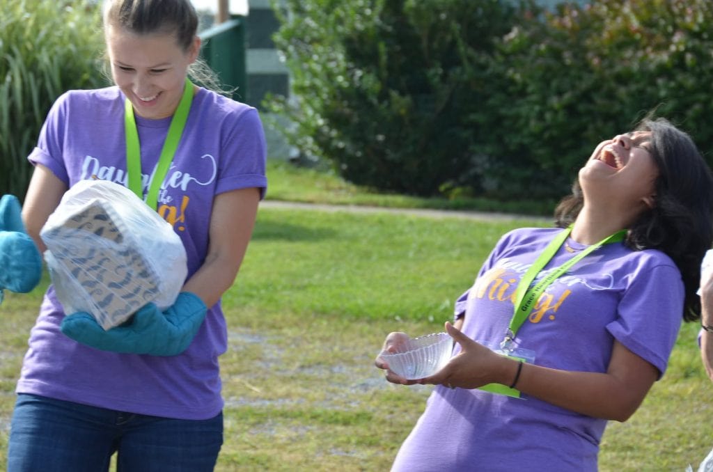 two women playing the saran wrap ball game laughing